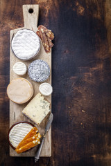 French cheese platter with spanish dulce de membrillo as top view on a wooden board
