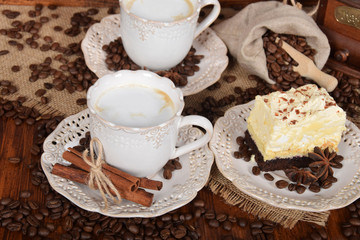 coffee cake with foam and chocolate sprinkles and delicious coffee with milk in retro cups