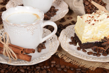coffee cake with foam and chocolate sprinkles and delicious coffee with milk in retro cups