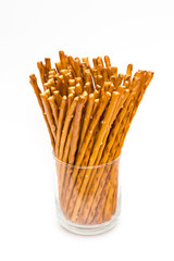 Salted sticks in glass on white background.