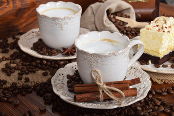 coffee with foam and vanilla chocolate cake and bag of coffee beans