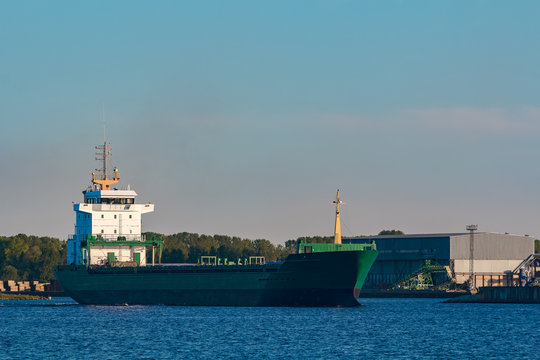Green cargo ship in port