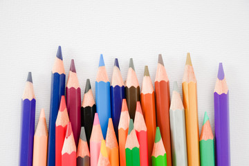 seamless colored pencils row on white painting paper background