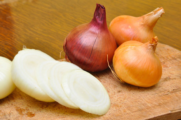 Fresh onion on cutting board. Cutting onion on rustic board