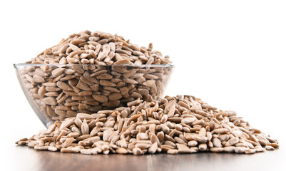 Bowl of shelled sunflower seeds isolated on white