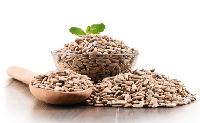Bowl of shelled sunflower seeds isolated on white