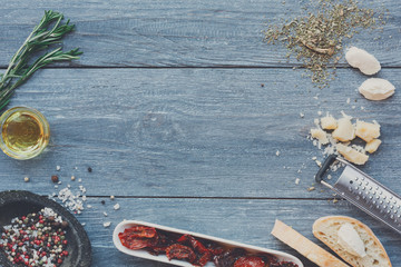 Italian cuisine ingredients background on blue rustic wood, copy space