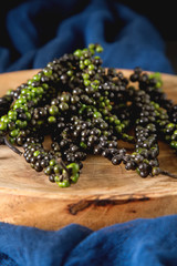 Black pepper on a dervish board. Dark background. Space for text.