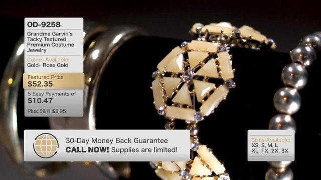 A fictional, QVC-like home shopping television content screen. Slowly rotating golden jewelry items with hypothetical graphics along the sides.  	