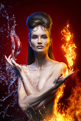 naked beautiful girl topless filled with a fire flames and water splashes on a red background