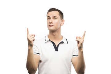 Fototapeta premium The young man points a fingers up isolated on a white