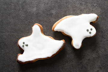 Sweet Halloween. Cookies in the form of ghosts. Dark background. Space for text.