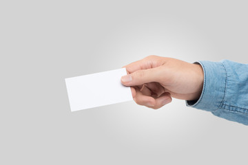 Obraz premium Male hand holding blank business card isolated