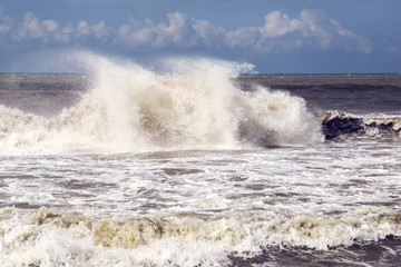 a hurricane and a storm with large waves