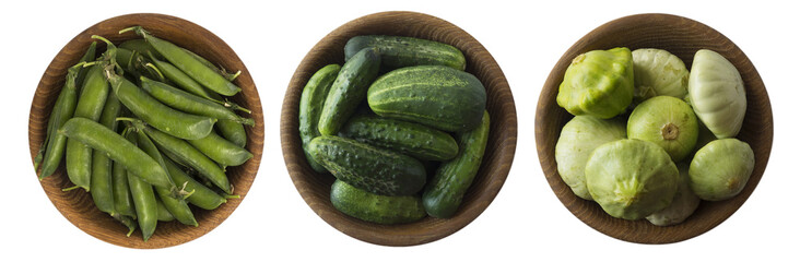 Broccoli, cucumber and green peas in wooden bowl. Top view. Vegetables isolated on a white background. Vegetables with copy space for text.
