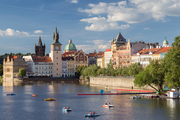 View of rowers at the Vltava River and old buildings at the Old Town in Prague, Czech Republic. © tuomaslehtinen