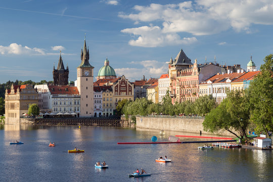 View of rowers at the Vltava River and old buildings at the Old Town in Prague, Czech Republic.