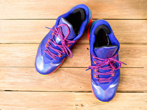 Basketball Sport shoes or sneakers on wooden board - Powered by Adobe