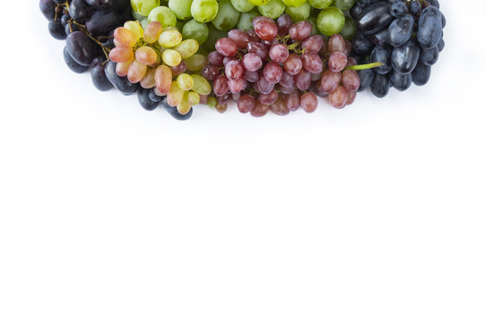 Grapes on white background. Grapes at border of image with copy space for text. Top view.