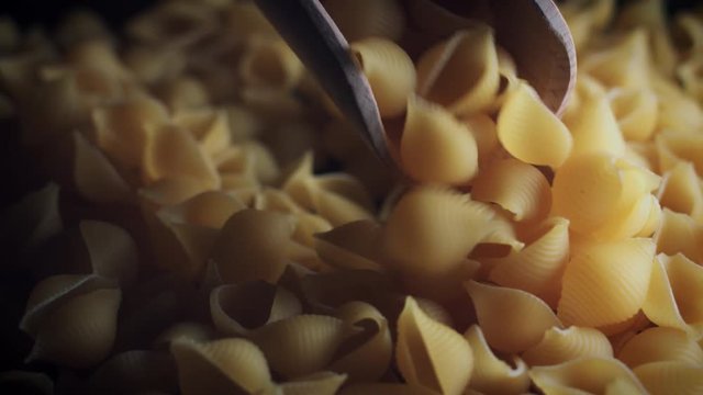 4k Dolly Shot of Italian Pasta Conchiglie in Scoop