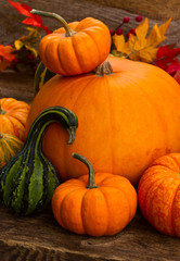 ripe of raw orange and green pumpkins on wooden table