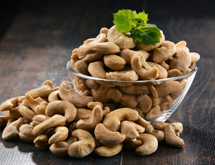 Bowl with cashew nuts on wooden table