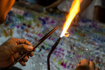 Close up a glass piece melted by a flame