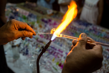 Close up a glass piece melted by a flame