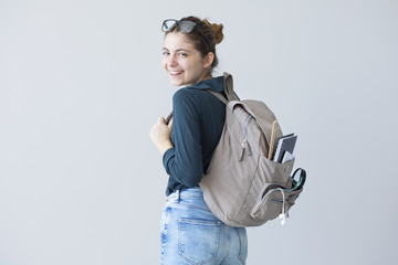 Fototapeta Portrait student with backpack on gray background obraz
