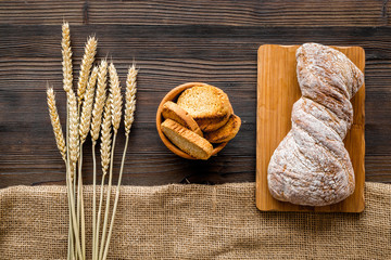 baking bread with wheat flour and ears on table rystic background top view