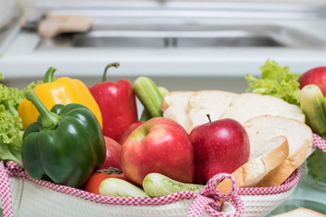 Fruits and vegetables for good health are placed on the table in the kitchen.