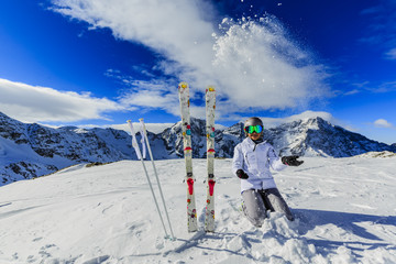 Teenager skiing in Italian Alps. In background blue sky and shiny sun and Ortler in South Tirol, Italy.  Adventure winter extreme sport.