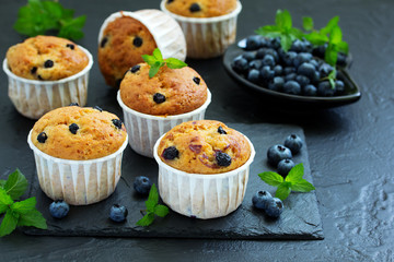 Oat muffins with blueberries on a dark background.