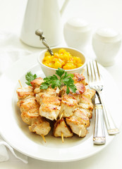 chicken skewers with apple-apricot chutney. Selective focus.