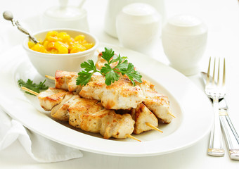 chicken skewers with apple-apricot chutney. Selective focus.