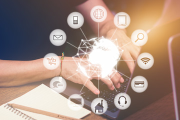 Hands typing on laptop and technology icon element concept