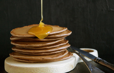 Chocolate pancakes with honey.