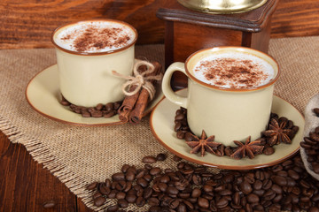 Fototapeta premium coffee with milk and chocolate foam in brown ceramic cups with vanilla and coffee grains