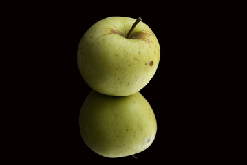 Green apple in a black background