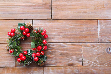 Christmas wreath on brown wooden table