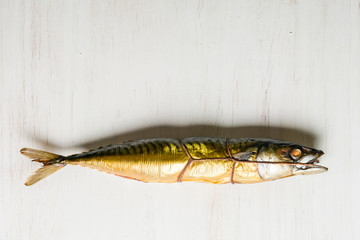 Whole mackerel hot smoked on a white wooden background. Horizontal position.