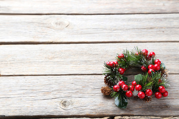 Fototapeta na wymiar Christmas wreath on grey wooden table