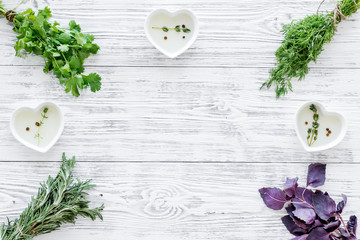natural oil and fresh greenery for restaurant cooking on wooden kitchen table background top view space for text