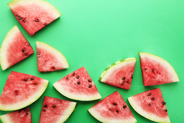 Slices of watermelons on green background