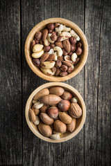Different types of nuts in wooden bowl.