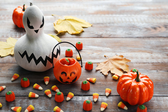 Halloween candy corns with ghost on wooden table