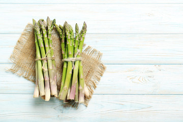 Fresh green asparagus on a blue wooden table