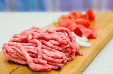 Raw minced meat and fresh vegetables. Ingredients for home cooking.