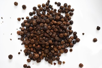 close up  black pepper on white plate 