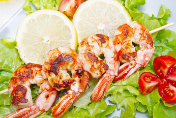 plate of grilled prawns with salad and cherry tomatoes